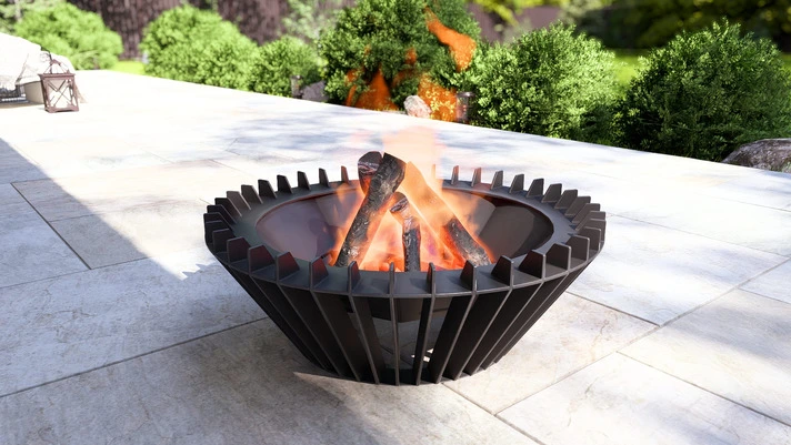 Close up of a faceted steel fire pit with flames